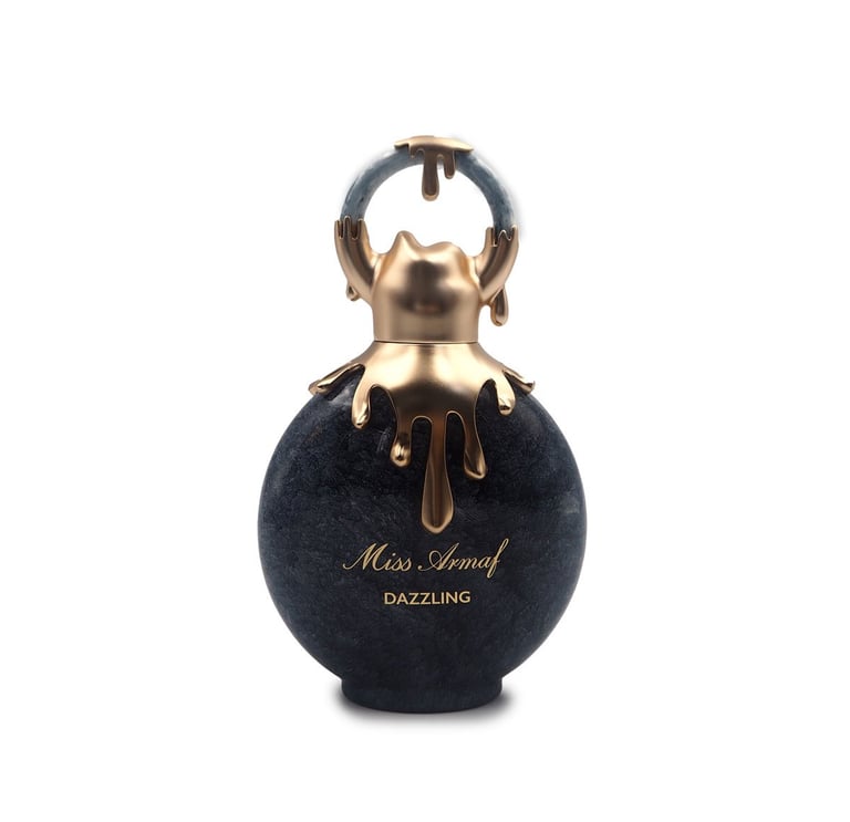 Black perfume bottle with gold cap and dripping detail, labeled Miss Asmat Dazzling