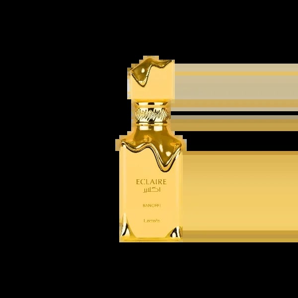 Gold bottle of Eclaire perfume by Bandoff with ornate wavy cap on white background